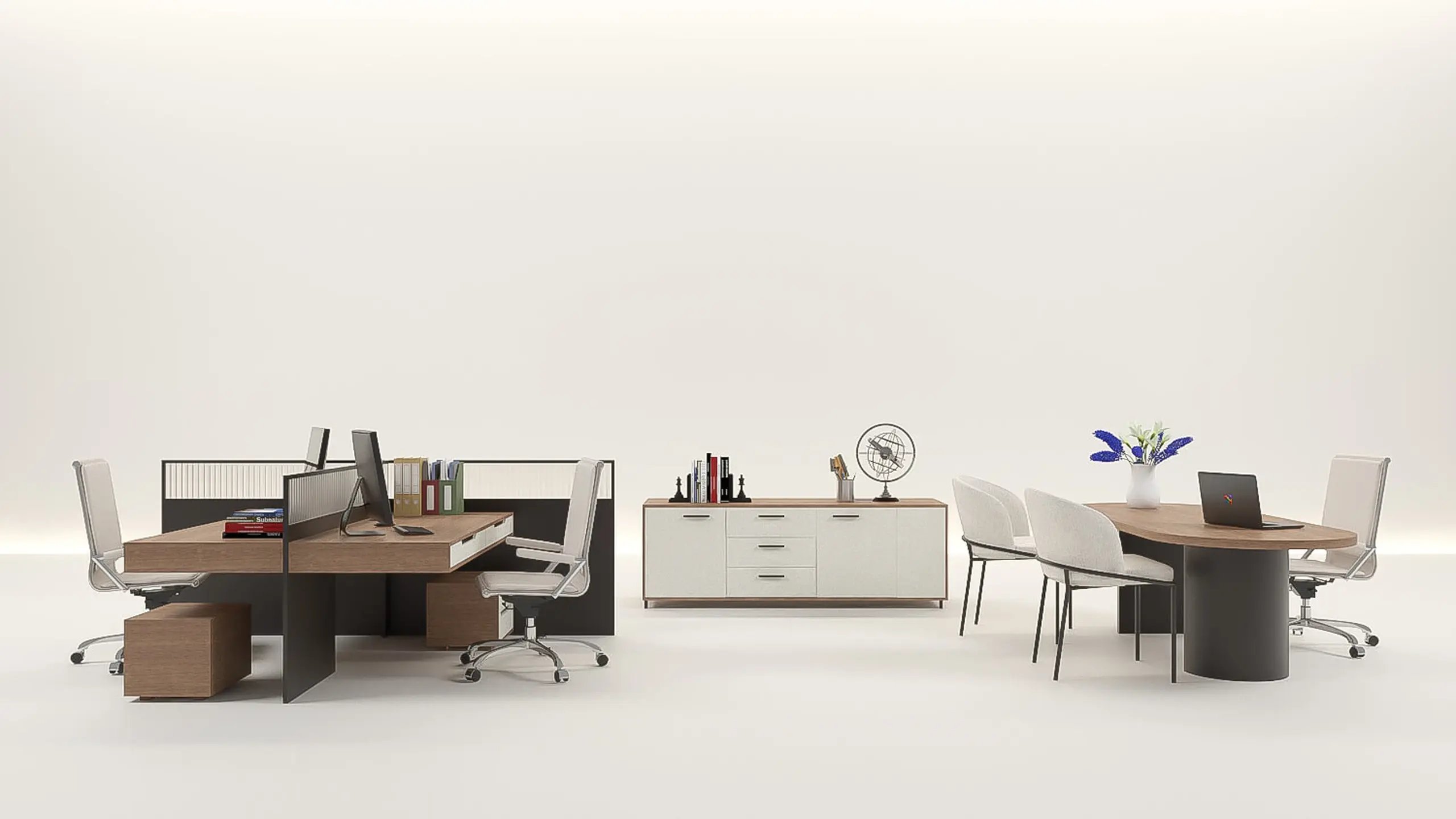 A two-person back-office desk cluster with monitors and a privacy screen, a storage sideboard, and a round meeting table with a laptop and chairs, on an open studio floor.
