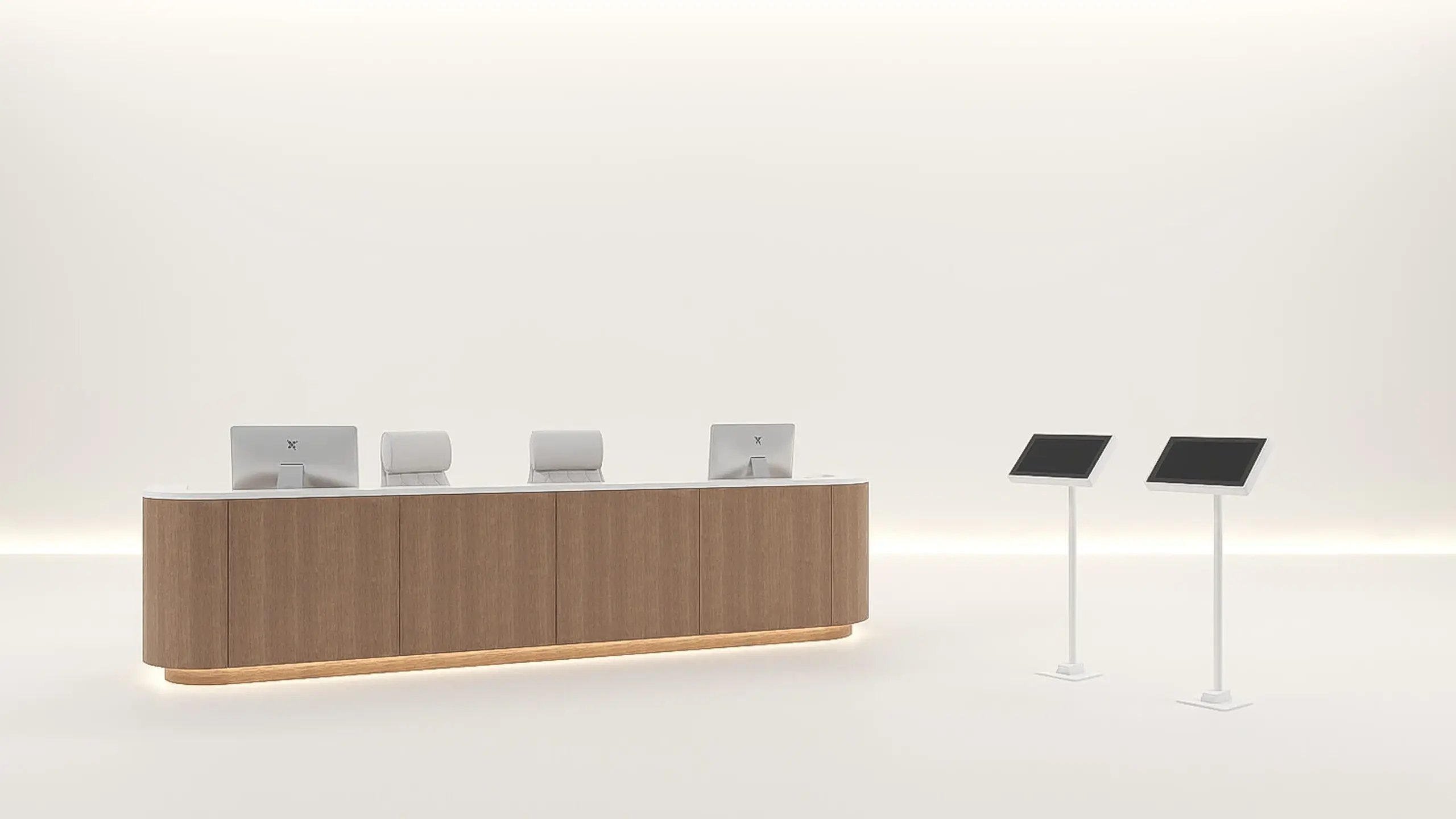 A curved wood-fronted reception counter with three check-in workstations, and two free-standing self-service check-in kiosks on posts, on an open studio floor.
