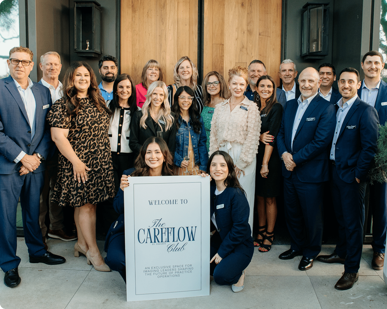 The AbbaDox team outside the CareFlow Club, gathered around a welcome sign