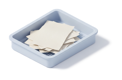 A desk tray holding a loose pile of faxed orders