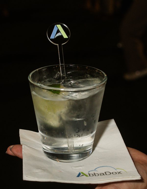 A drink with an AbbaDox A stirrer on an AbbaDox napkin at the PaRADigm 2026 reception
