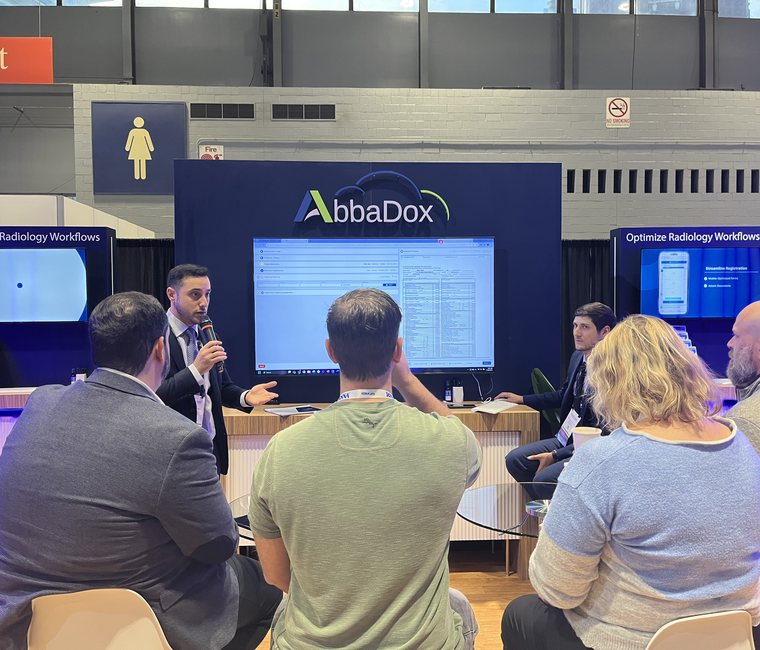 An AbbaDox specialist running a live demo for a seated audience at the stand at RSNA 2023