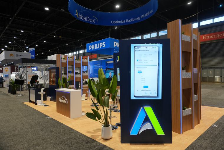 The AbbaDox stand at RSNA 2024, the lit A panel and the screens