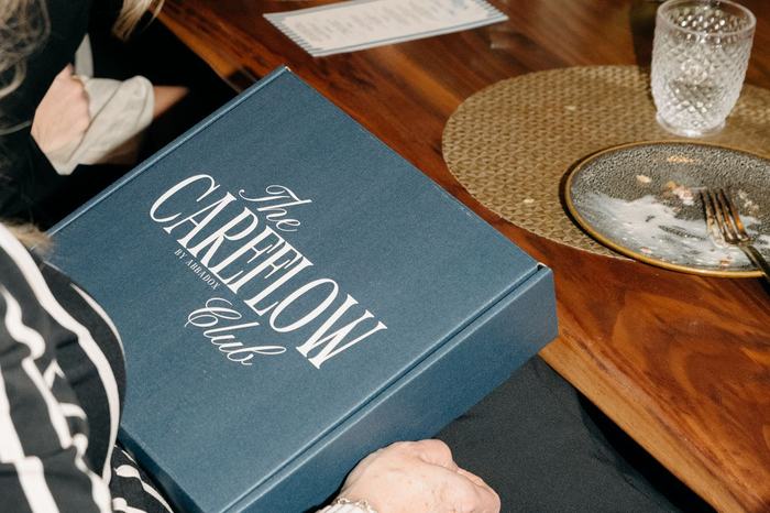 The navy CareFlow Club menu folder on the table in Houston