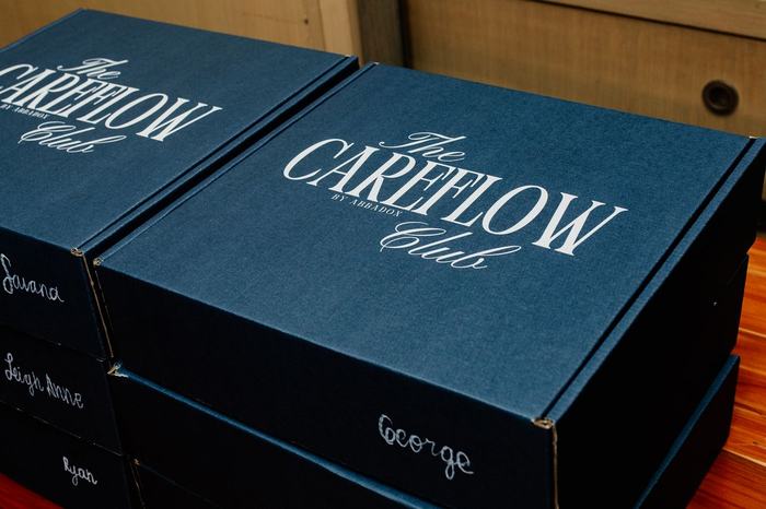 Navy CareFlow Club gift boxes, each lettered with a guest name, in Orlando