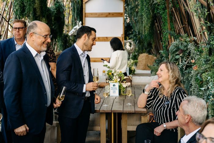 Guests talking over champagne at the Houston cocktail table before dinner
