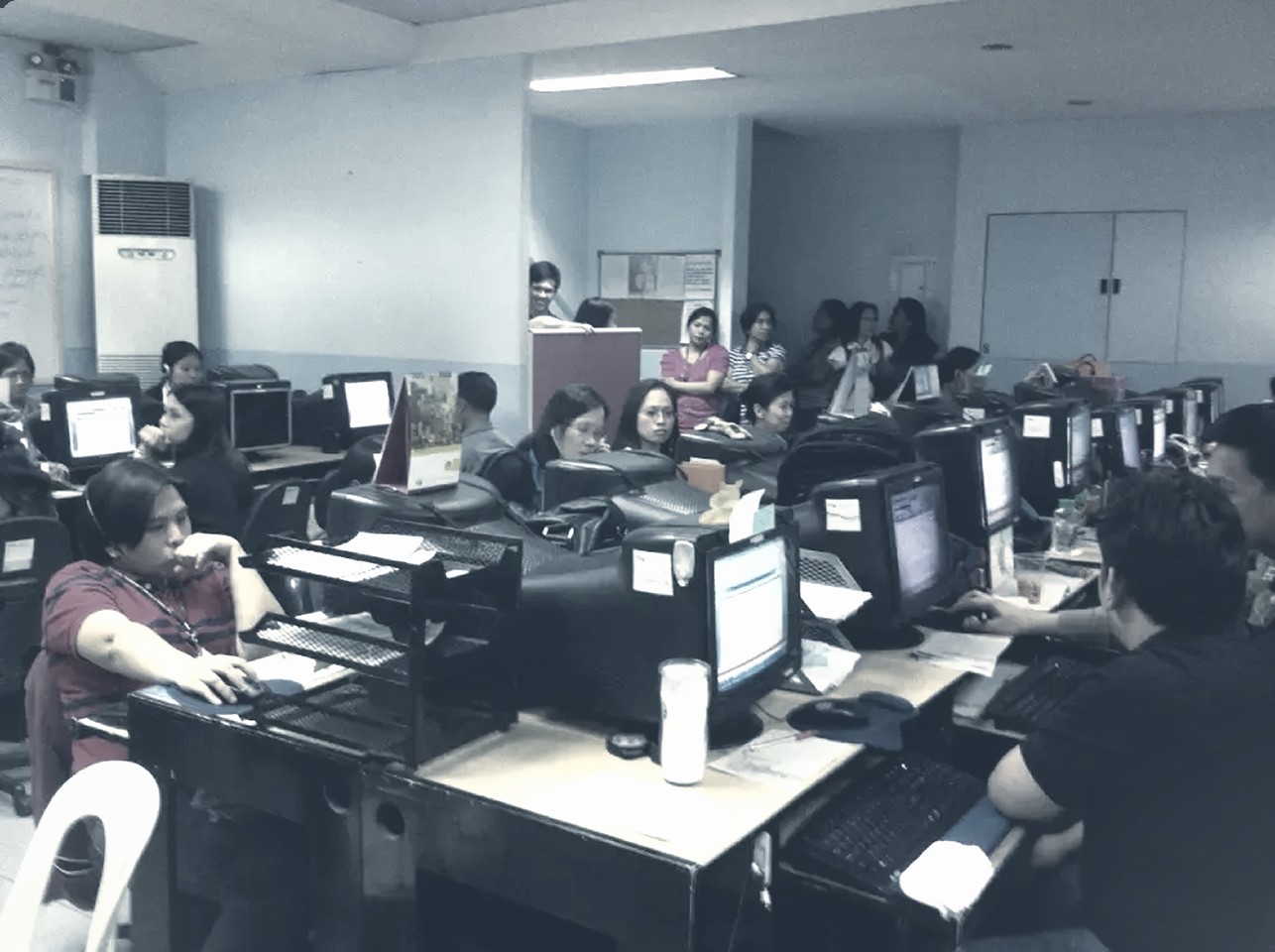 AbbaDox's first operations floor: staff at rows of desktop workstations working through imaging paperwork